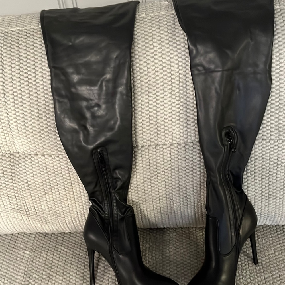 Black leather thigh high boots.